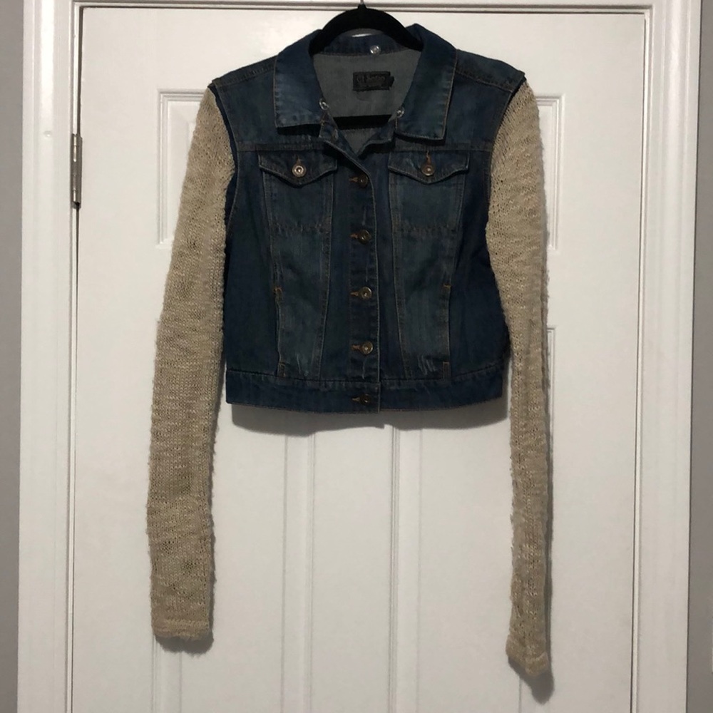 Distressed jean jacket with tan sleeves
